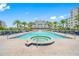 Inviting resort-style pool and spa with ample lounge chairs at 6 Hibiscus Ln, Belleair, FL 33756