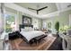 Main bedroom with king bed, hardwood floors, and access to balcony at 6 Hibiscus Ln, Belleair, FL 33756