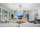 Spacious living area with built-in shelving, fireplace, and large windows at 6 Hibiscus Ln, Belleair, FL 33756