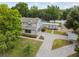 Aerial view of a house with a large yard, detached garage and lake view at 15504 Race Track Rd, Odessa, FL 33556