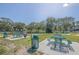 Relaxing picnic area with tables and grills near a lake at 2210 Utopian E Dr # 206, Clearwater, FL 33763