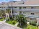 Two-story condo building with balconies and landscaping at 2210 Utopian E Dr # 206, Clearwater, FL 33763