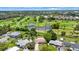 Aerial view showcasing the house and neighborhood's golf course at 12297 Croft Dr, Largo, FL 33774