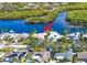 Aerial view of a waterfront community with lush tropical landscaping with mature palms at 1964 Arvis E Cir, Clearwater, FL 33764