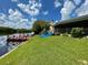 Expansive backyard with lush lawn leading to a private dock and waterfront access at 1964 Arvis E Cir, Clearwater, FL 33764