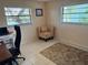 Cozy bedroom featuring a comfortable chair, bright windows, and neutral tones for a relaxing atmosphere at 1964 Arvis E Cir, Clearwater, FL 33764