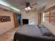 Bedroom with tiled floors, ceiling fan and large window at 1964 Arvis E Cir, Clearwater, FL 33764
