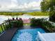 Waterfront deck with lounge chairs and views of the lush tropical landscape at 1964 Arvis E Cir, Clearwater, FL 33764