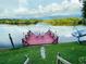 Inviting waterfront property featuring a private dock with chairs and stunning views at 1964 Arvis E Cir, Clearwater, FL 33764