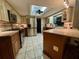 Bright kitchen featuring tile floors, stainless steel appliances, granite countertops, and a skylight at 1964 Arvis E Cir, Clearwater, FL 33764