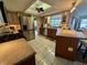 Bright kitchen featuring tile floors, stainless steel appliances, and granite countertops at 1964 Arvis E Cir, Clearwater, FL 33764
