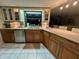 The kitchen features custom cabinets, a view to the backyard, and updated appliances at 1964 Arvis E Cir, Clearwater, FL 33764