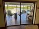 Screened-in lanai overlooking water with seating, tile floor and bar at 1964 Arvis E Cir, Clearwater, FL 33764