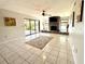 Inviting living room featuring tile floors, fireplace, and sliding glass door access at 1964 Arvis E Cir, Clearwater, FL 33764