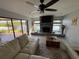 Living room with fireplace and waterfront views, providing a relaxing and scenic atmosphere at 1964 Arvis E Cir, Clearwater, FL 33764