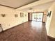 Open living room with tile floors, recessed lighting, and sliding glass doors to the outside at 1964 Arvis E Cir, Clearwater, FL 33764
