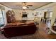Spacious living room with comfortable leather seating and an open layout to the dining area at 1964 Arvis E Cir, Clearwater, FL 33764