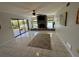 Spacious living room with tile floors, brick fireplace and sliding glass doors to the patio at 1964 Arvis E Cir, Clearwater, FL 33764