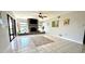 Open-concept living room featuring a brick fireplace and tile flooring at 1964 Arvis E Cir, Clearwater, FL 33764