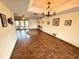 Inviting living room with tile floors, chandelier, and access to outdoor space at 1964 Arvis E Cir, Clearwater, FL 33764