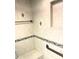 Walk-in shower featuring neutral tiling, grab bars, and built-in shelving for convenience at 1964 Arvis E Cir, Clearwater, FL 33764