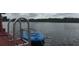 Scenic waterfront view with a blue paddleboard floating near a wooden dock at 1964 Arvis E Cir, Clearwater, FL 33764