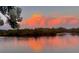 Scenic water view at sunset, with vibrant reflections of the colorful sky on the serene water surface at 1964 Arvis E Cir, Clearwater, FL 33764