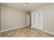 Well-lit bedroom featuring tile floors and a double door closet at 10119 N Ola Ave, Tampa, FL 33612