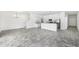 Open living room and kitchen area with grey plank flooring at 7535 62Nd N Way, Pinellas Park, FL 33781