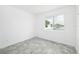 Spacious bedroom with large window and grey flooring at 7535 62Nd N Way, Pinellas Park, FL 33781