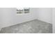 Bright bedroom with large window and grey flooring at 7535 62Nd N Way, Pinellas Park, FL 33781
