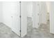 Clean hallway with white doors and grey flooring at 7535 62Nd N Way, Pinellas Park, FL 33781