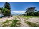 Vacant lot with patchy grass and a distant view of houses at 303 Harbor Dr, Indian Rocks Beach, FL 33785