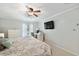 King-size bed in a grey bedroom with a desk and TV at 5257 Beach Se Dr # D, St Petersburg, FL 33705
