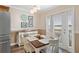 Bright dining area with a table for four and access to a balcony at 5257 Beach Se Dr # D, St Petersburg, FL 33705