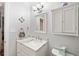 Updated bathroom features a white vanity with quartz countertop and a stylish medicine cabinet at 5257 Beach Se Dr # D, St Petersburg, FL 33705