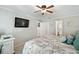 King-size bed in a grey bedroom with ensuite bathroom and TV at 5257 Beach Se Dr # D, St Petersburg, FL 33705
