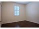 Simple bedroom with hardwood floors and plantation shutters at 7323 Night Heron Dr, Land O Lakes, FL 34637