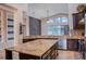 Kitchen with large island, granite countertops, and stainless steel appliances at 7323 Night Heron Dr, Land O Lakes, FL 34637