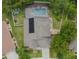 Aerial view of a home with a solar panel system and pool at 7323 Night Heron Dr, Land O Lakes, FL 34637