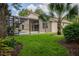 Home with a screened pool and lanai, lush landscaping, and spacious backyard at 7323 Night Heron Dr, Land O Lakes, FL 34637