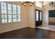 Elegant dining room with dark hardwood floors and ornate chandelier at 7323 Night Heron Dr, Land O Lakes, FL 34637