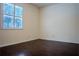 Bright bedroom with dark wood flooring and window shutters at 7323 Night Heron Dr, Land O Lakes, FL 34637