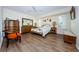 Bedroom featuring a gold bed frame, wooden furniture, and an ensuite bathroom at 1008 Caravel Ct, Tarpon Springs, FL 34689