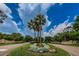 Ornate landscaping and palm trees at the entrance to Pointe Alexis at 1008 Caravel Ct, Tarpon Springs, FL 34689