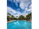 Inviting community pool with blue umbrellas and lounge chairs at 1008 Caravel Ct, Tarpon Springs, FL 34689