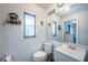 Bathroom featuring toilet, sink, and large mirror at 2790 Hillsdale Ave, Largo, FL 33774