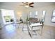 Bright living room with tiled floors, comfy seating, and access to a balcony at 702 Lyndhurst St # 824, Dunedin, FL 34698