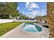 Inviting kidney-shaped pool surrounded by a spacious grassy backyard at 831 Searcy Ave, Sarasota, FL 34237