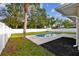 Relaxing kidney-shaped pool with a large backyard and privacy fence at 831 Searcy Ave, Sarasota, FL 34237